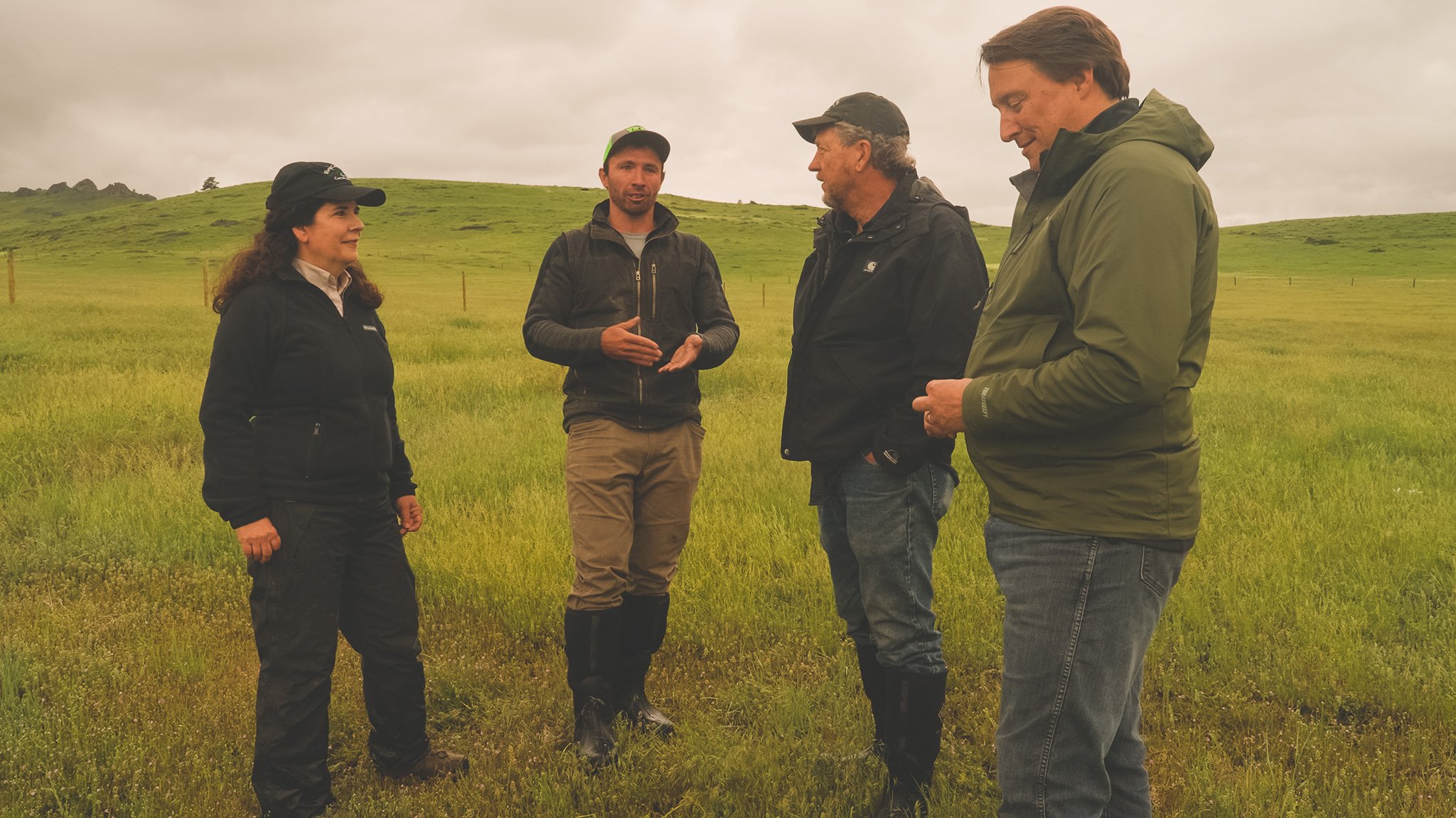 A group of Mast employees stand next to Don Harland and Zack Bashoor.