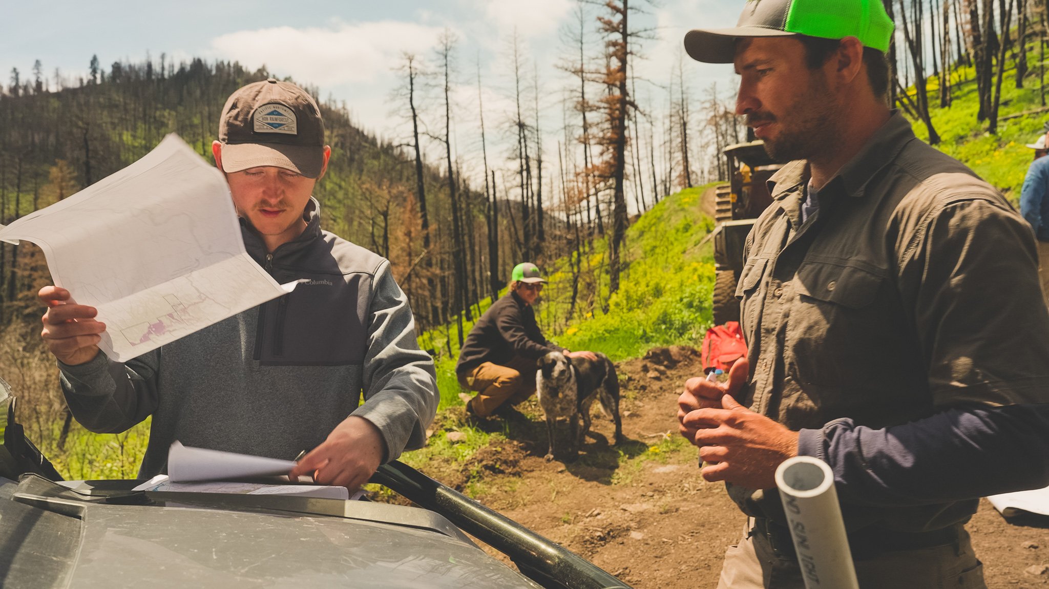 Zack Bashoor and a mast employee look at a map.